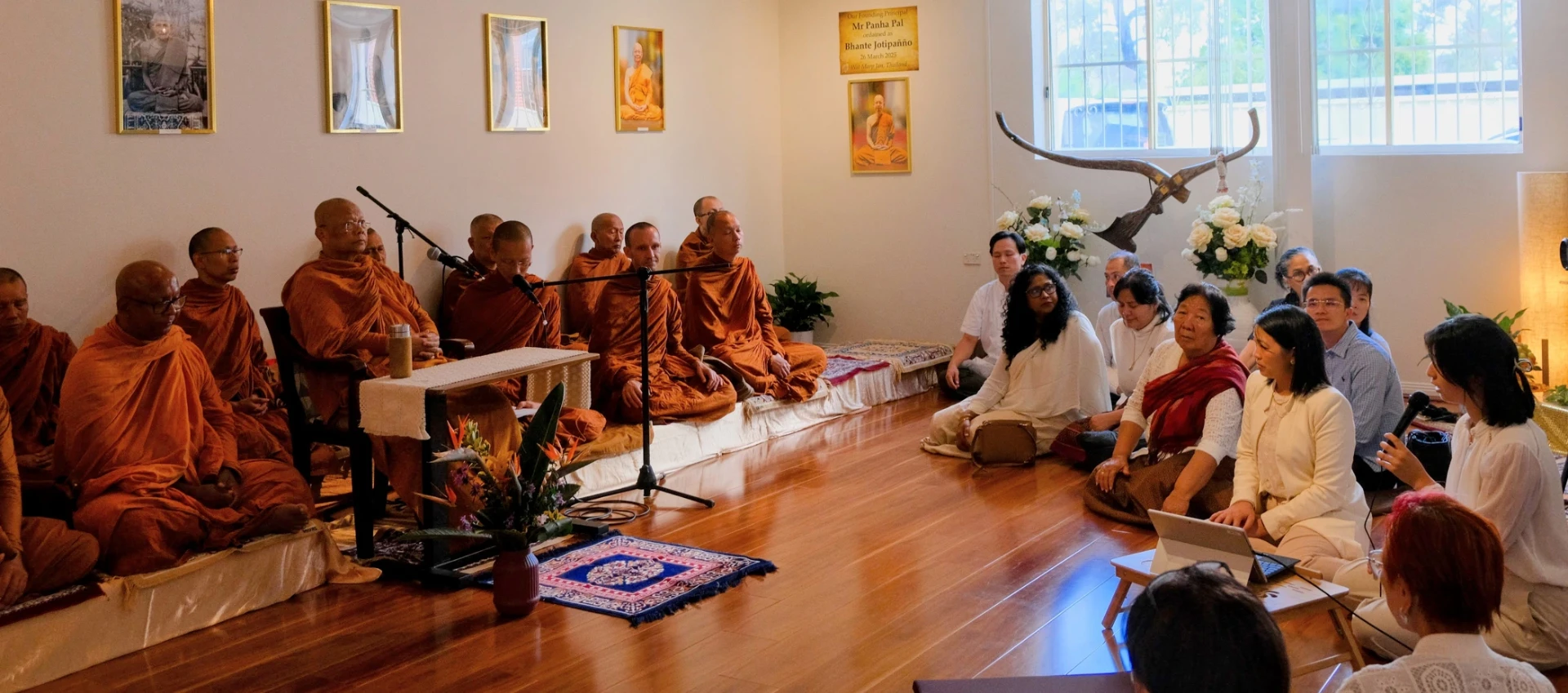 Lay people sitting quietly in practice in a plain hall