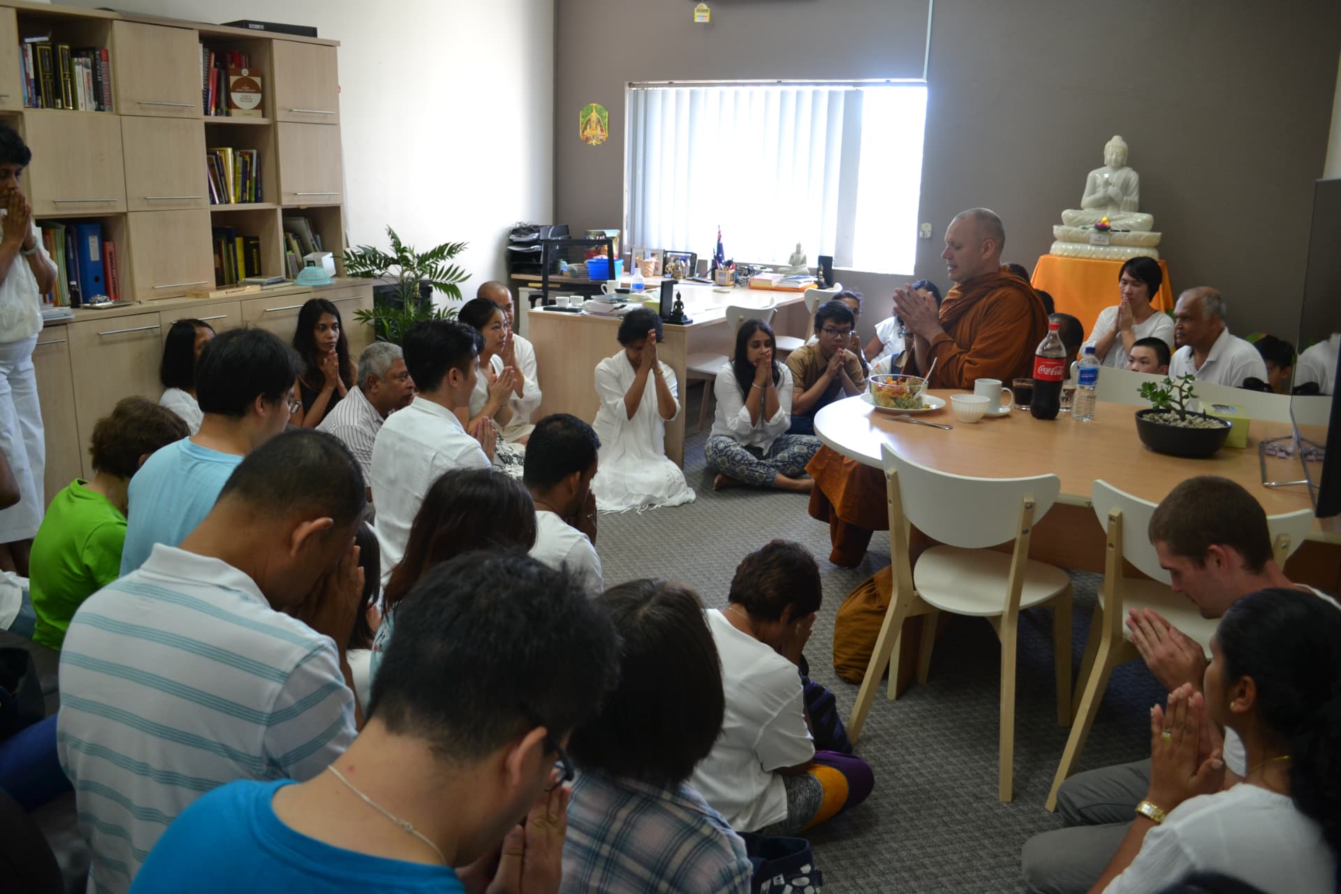 People sharing tea and conversation after a talk